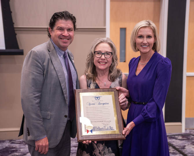 TCU Chancellor Daniel Pullin, left, Dr. Suzy Lockwood, center, and City of Fort Worth Councilwoman Macy Hill, right, with a proclamation from the city in recognition of 80 years of nursing at TCU.